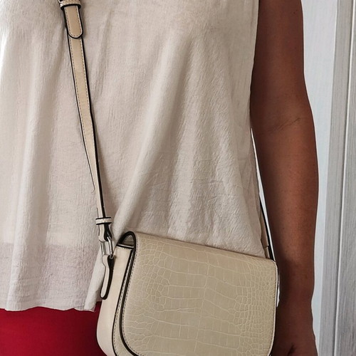 Beige crossbody bag used with adjustable strap