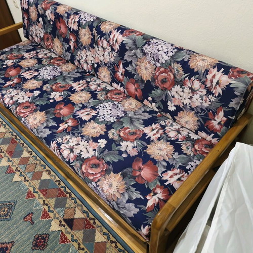 Three-seater sofa with pull-out bed and floral upholstery