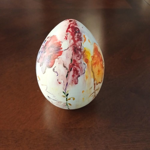 Hand-painted ceramic egg with floral and female figure design