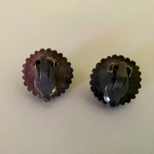 Vintage clip-on earrings with embossed marcasite-style details, used