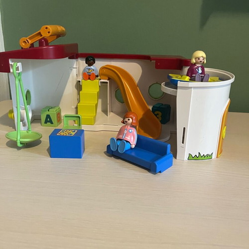 Playmobil set with three figures, slide, swing, and desk chair used