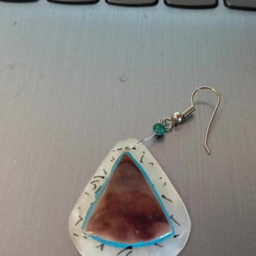 Single earring used, beige and blue