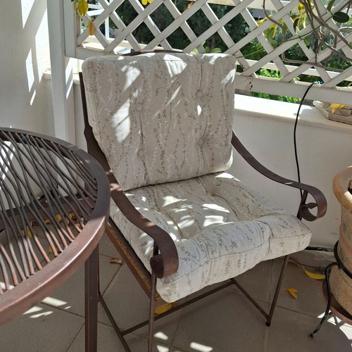 Retro wrought iron garden armchair with cushions used
