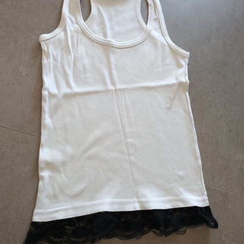 White top with black lace hem, X-back cut