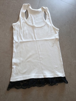 White top with black lace hem, X-back cut
