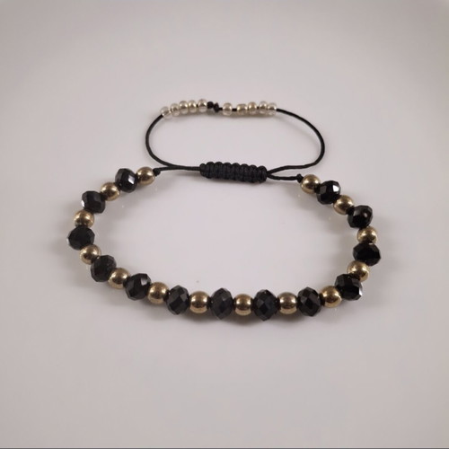 Handmade bracelet with black crystals and gold hematite beads, adjustable cord