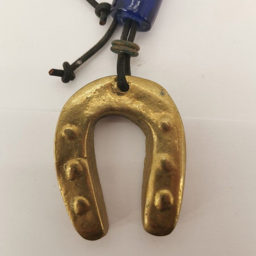 Bronze horseshoe charm used with small glass bead