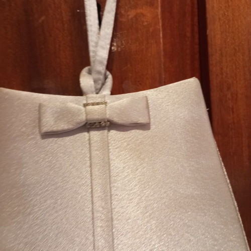 Silver satin evening bag with bow and wrist strap