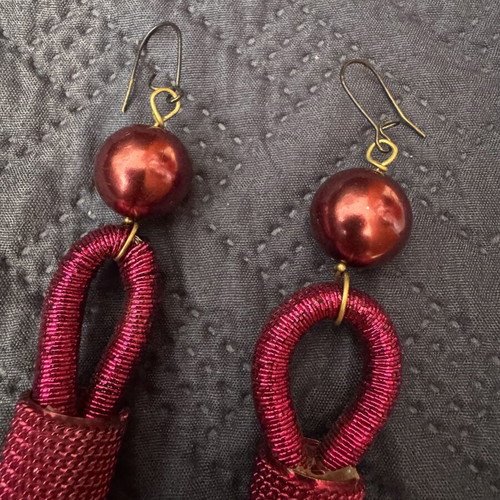Red earrings with intricate binding and tassel like new