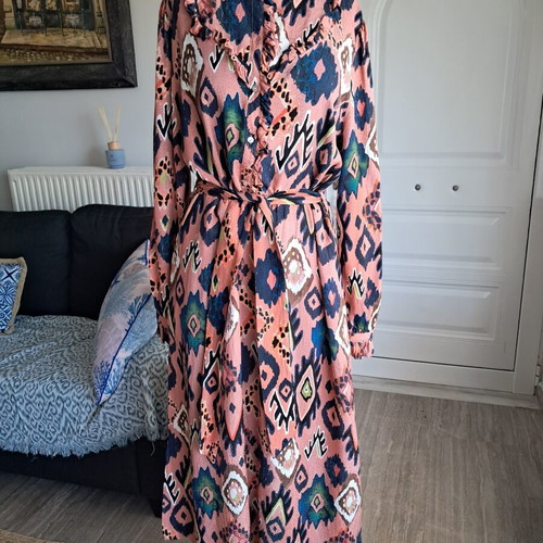 Pom dress used with geometric pattern in pink, blue and green