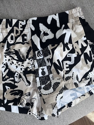Adidas shorts M, black and beige graphic print