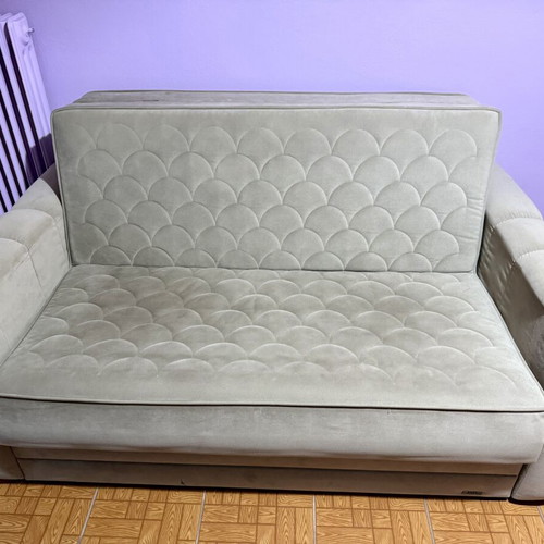 Two-seater sofa light brown/grey like new, folds into a bed