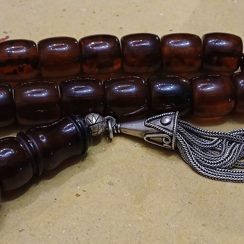 Amber worry beads used with silver elements and tassel