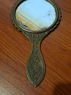 Brass hand mirror used with embossed peacock decoration