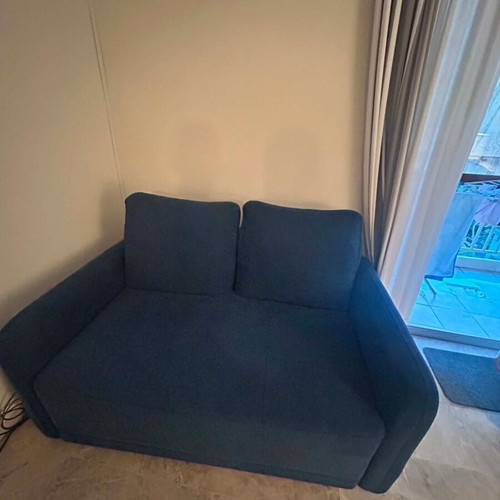 Blue two-seater sofa used with metal legs
