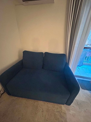 Blue two-seater sofa used with metal legs