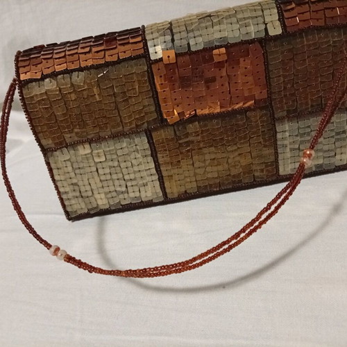 Official hand bag like new in brown shades with sequins