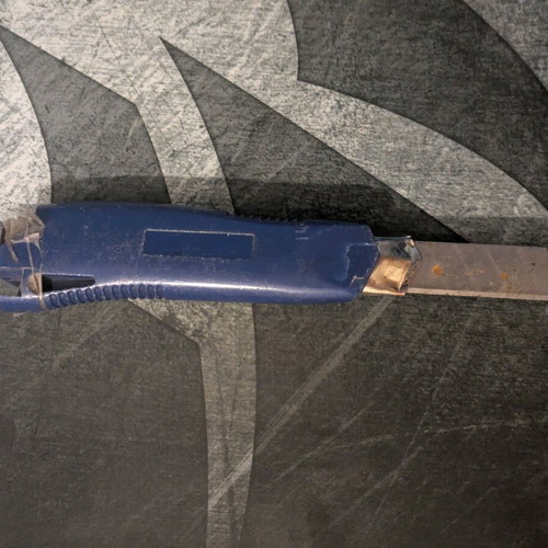 Blue utility knife used with broken back edge