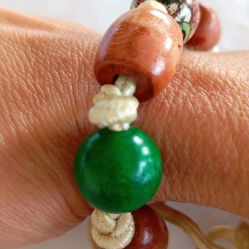 Handmade bracelet with cord and wooden beads green and brown