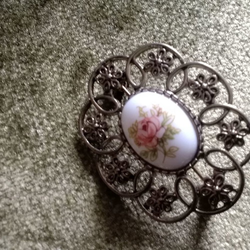 Metal brooch with porcelain detail used
