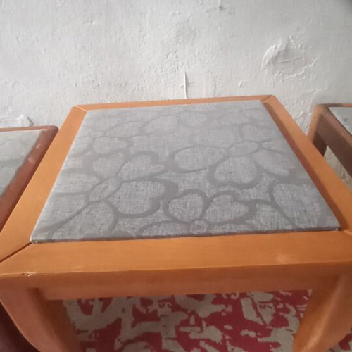 Wooden side tables with plastic protection and decorative fabric