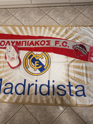 Real Madrid and Olympiakos accessories used with flag, scarf, and cap