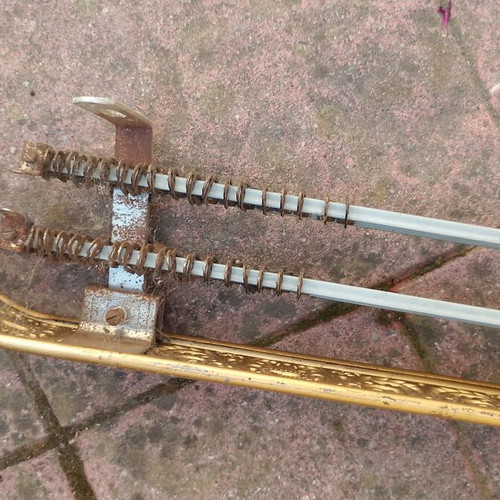 Metallic vintage curtain rail with brass coloured details used