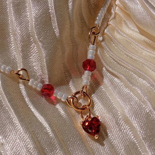 Rosary necklace with white and red beads and heart pendant