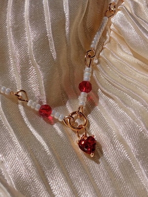 Rosary necklace with white and red beads and heart pendant