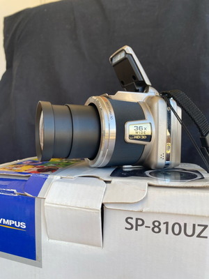 Olympus SP-810UZ digital camera used with accessories