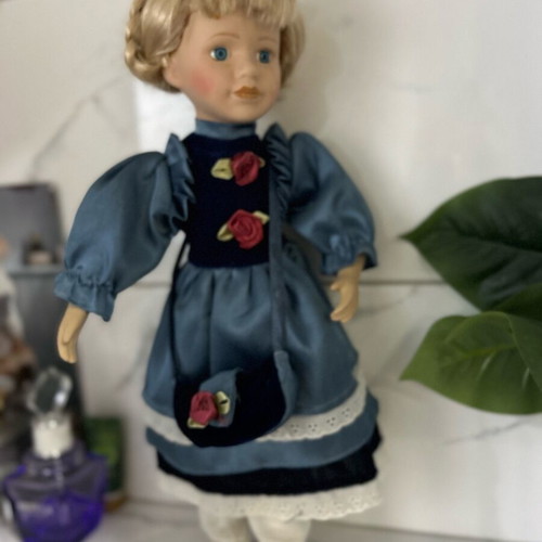 Porcelain doll like new vintage with blue satin dress