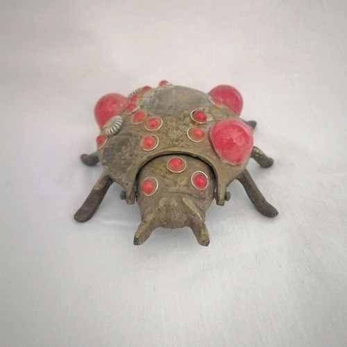 Bronze ashtray used with red scarab-shaped stones