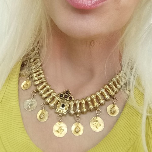 Traditional necklace with vintage symbols used, yellow light color, copper
