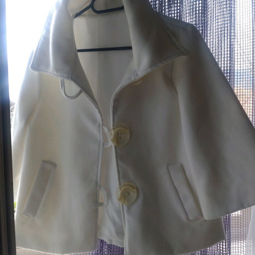 White jacket used, mid-length with 3/4 sleeves, 70% wool