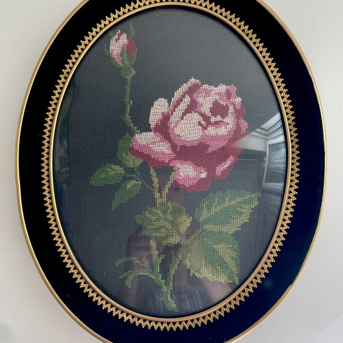 Embroidery frame with rose on black background