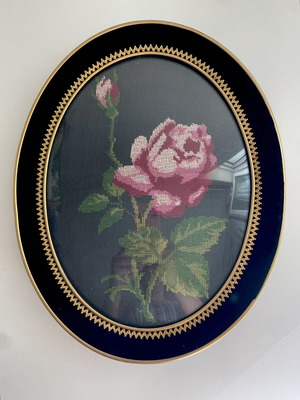Embroidery frame with rose on black background