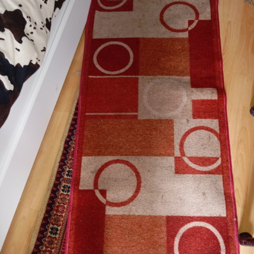 Vintage carpet runner used with geometric motifs in warm colors