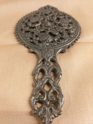 Carved old hand mirror used