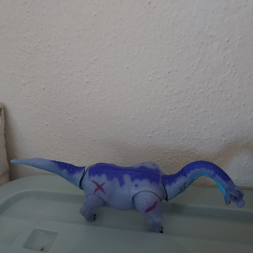 Dinosaur toy like new, purple with movable head and tail