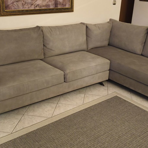 Corner sofa like new in grey/beige taupe color with decorative pillows