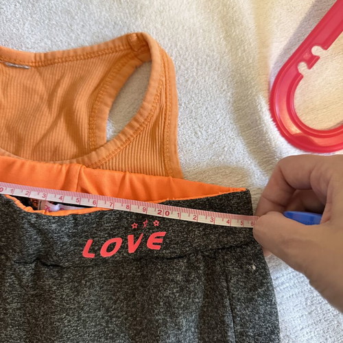 Girls' sports set with grey leggings and orange tank top, size 10