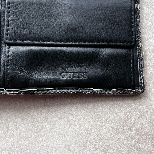 Guess wallet used with visible wear, black