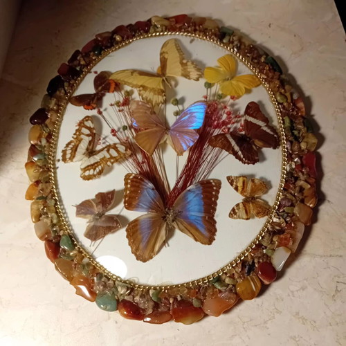 Vintage framed art with colorful stones and butterflies