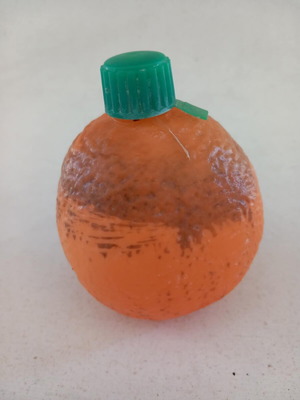 Plastic orange-shaped bottle used for beverage