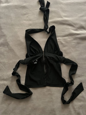 Black halter top with gold detail and open back