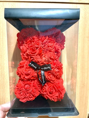 Handmade teddy bear made of red artificial roses