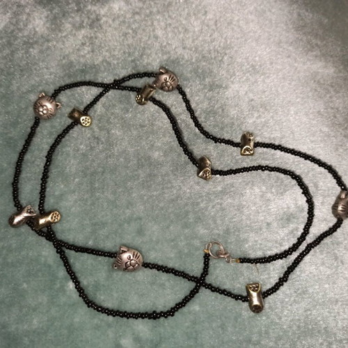 Long necklace with cat faces and paw charms like new
