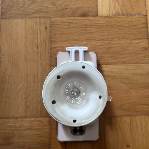 White mobile phone holder used with strong suction cup for car