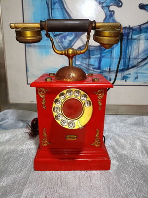 Vintage metal rotary phone, red with gold details