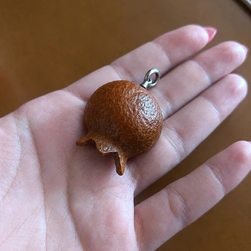 Handmade pomegranate pendant from natural material, like new